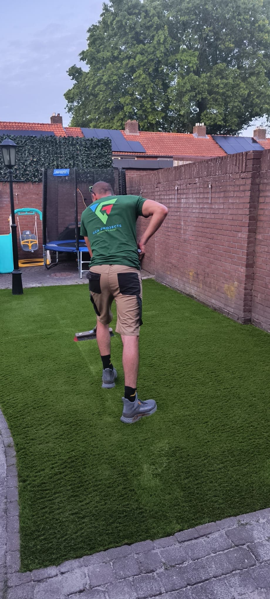 GCA Projects crew member finishing a fresh artificial lawn
