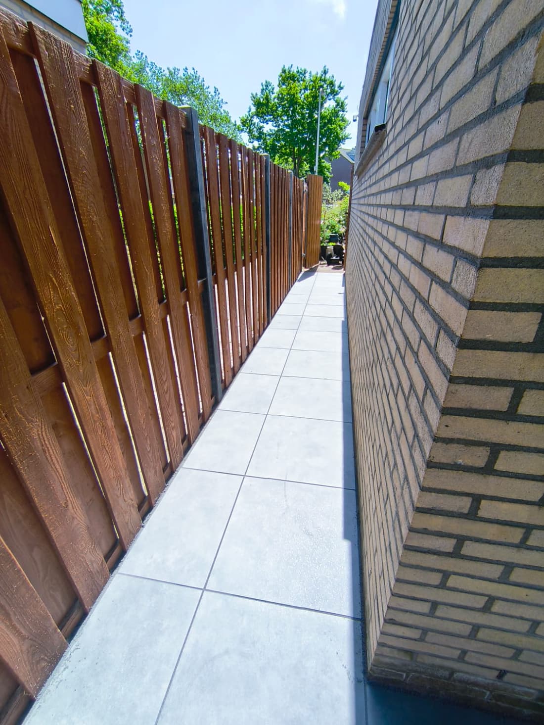 New timber slat privacy fence along a re-paved side passage